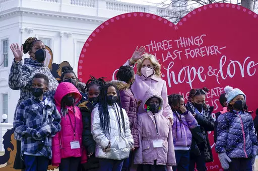 First lady Jill Biden poses for a photo with Aiton Elementary School students and staff as she welcomes school children to the White House in Washington, Monday, Feb. 14, 2022, to celebrate Valentine's Day. (AP Photo/Susan Walsh)