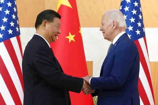 U.S. President Joe Biden, right, and Chinese President Xi Jinping shake hands before their meeting on the sidelines of the G20 summit meeting, Monday, Nov. 14, 2022, in Nusa Dua, in Bali, Indonesia. (AP Photo/Alex Brandon)