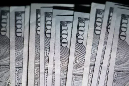 U.S. $100 bills are seen, Thursday, July 14, 2022, in Marple Township, Pa. Now that retirement spans more years than ever, you might need to rethink how you’re envisioning that stage of your life. It’s not a blip on the life radar — it’s a significant chunk of time. (AP Photo/Matt Slocum, File)
