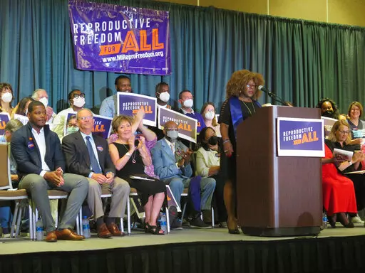 Elder Leslie Mathews, an organizer with Michigan United joins Leaders of the Reproductive Freedom for All campaign as they speak to supporters on Monday, July 11, 2022, in Lansing Mich., after turning in 753,759 signatures to qualify for Michigan's November ballot. (AP Photo/Joey Cappelletti)