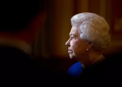In this Dec. 18, 2012 file photo Britain's Queen Elizabeth II escorted by British Foreign Secretary William Hague, unseen, tours The Foreign and Commonwealth Office during an official visit which is part of her Jubilee celebrations in London.  Queen Elizabeth II, Britain’s longest-reigning monarch and a rock of stability across much of a turbulent century, has died. She was 96. Buckingham Palace made the announcement in a statement on Thursday Sept. 8, 2022. (AP Photo/Alastair Grant, Pool, Fil