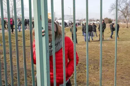 Ukranian refugees wait for family members to arrive, at Medyka border crossing, in Medyka, Poland, Saturday, Feb. 26, 2022. The United Nations says that more than 3.6 million people have fled Ukraine since the war started exactly one month ago Thursday, in what is the biggest movement of people in Europe since World War II. Unprepared, most refugees believed they would soon be back home. That hope is waning now. (AP Photo/Visar Kryeziu, File)