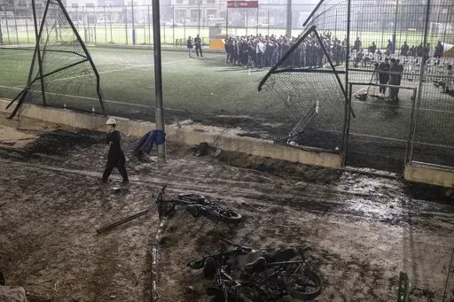A boy walks past bicycles left next to a soccer pitch that was hit by a rocket, killing 12 children and teenagers, in the Druze town of Majdal Shams, in the Israeli-annexed Golan Heights, Saturday, July 27, 2024. Two days after the attack questions remain about why it happened and who is responsible. (AP Photo/Leo Correa, File)