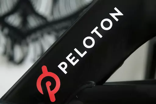 A Peloton logo is seen on the company's stationary bicycle on Nov. 19, 2019, in San Francisco, Calif. Peloton is recalling more than 2 million of its exercise bikes because the bike’s seat post assembly can break during use, posing fall and injury hazards. (AP Photo/Jeff Chiu, File)