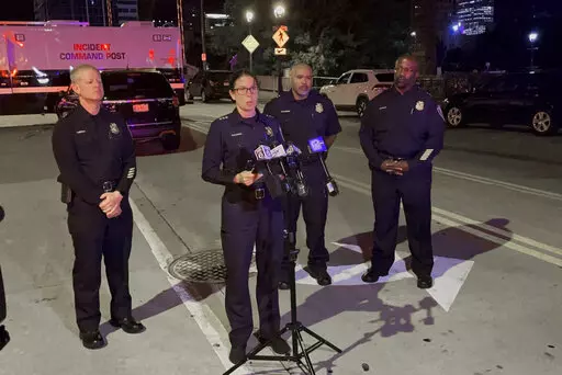 Assistant Police Chief Nicole J. Waldner holds a news conference early Saturday, Sept. 3, 2022 following a fatal shooting downtown Milwaukee.  A man was killed by Milwaukee officers after he led them on a chase into a busy downtown bar district, then got out of his vehicle and opened fire on them, police said.  One bystander was hit by gunfire in the Friday night shootout, police said. (Drake Bentley/Milwaukee Journal-Sentinel via AP)