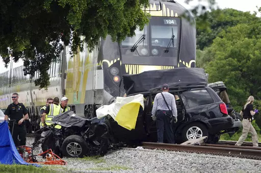 In this Aug 25, 2019 file photo, Broward Sheriff's Deputies and Pompano Beach Fire Rescue work the scene of a fatal accident on North Dixie Highway in Pompano Beach, Fla. South Florida's higher-speed railroad, other train lines and local officials  met with federal safety officials Wednesday, Feb. 23, 2022 to begin working out plans that they hope will decrease the number of fatal strikes between locomotives, cars and pedestrians. (Joe Cavaretta/South Florida Sun-Sentinel via AP)