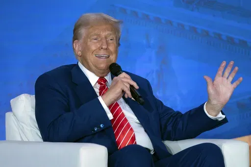 Republican presidential nominee former President Donald Trump speaks with Moms for Liberty co-founder Tiffany Justice during an event at the group's annual convention in Washington, Friday, Aug. 30, 2024. (AP Photo/Jose Luis Magana)