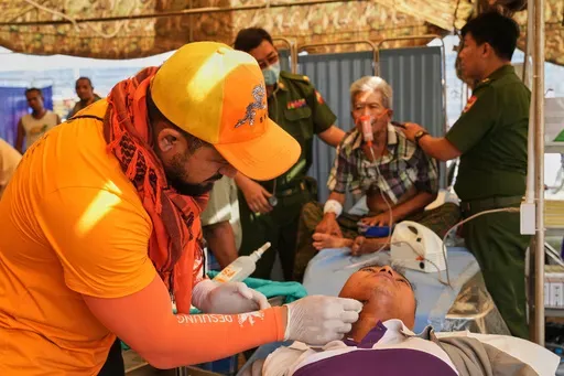 A Bhutan medical volunteer attends to a patient at their make-shift tent after last week's earthquake in Naypyitaw, Myanmar, Friday, April 4, 2025. (AP Photo)
