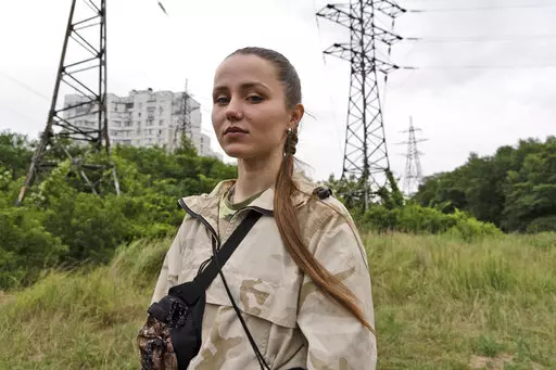 Instructor Ilona Khomenko looks on during a first aid training to master the MARCH algorithm according to the NATO protocol, in Kyiv, Ukraine, Monday, July 11, 2022. Khomenko’s life changed on May 23, when her husband died fighting the near Severodonetsk in eastern Ukraine. Now she keeps him close by helping to train soldiers and civilians how to survive on the battlefield. (AP Photo/Vasilisa Stepanenko)