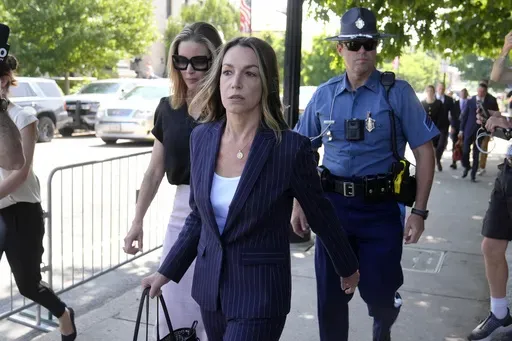 Karen Read, center, departs Norfolk Superior Court, Wednesday, June 26, 2024, in Dedham, Mass. Read is on trial, accused of killing her boyfriend Boston police Officer John O'Keefe, in 2022. The jury began deliberations in the trial Tuesday. (AP Photo/Steven Senne)