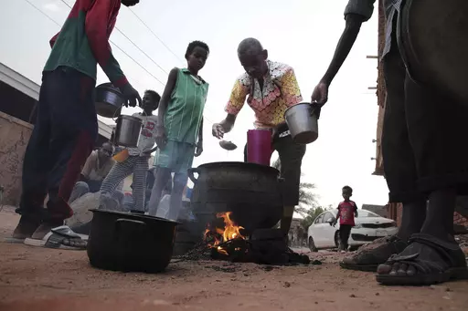 People prepare food in a Khrtoum neighborhood on June 16, 2023. Sudan’s warring parties began a cease-fire Sunday morning, June 18, 2023, after two months of fighting pushed the African nation into chaos. (AP Photo, File)