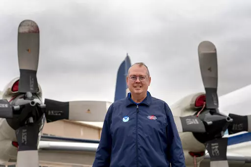 National Hurricane Center Director Ken Graham poses for a portrait in front of WP-3D Orion "hurricane hunter" aircraft during a hurricane awareness tour at Washington National Airport, Arlington, Va., May 3, 2022. The National Oceanic and Atmospheric Administration on Tuesday, June 7, named Graham the overall boss of the weather service. (AP Photo/Gemunu Amarasinghe, File)