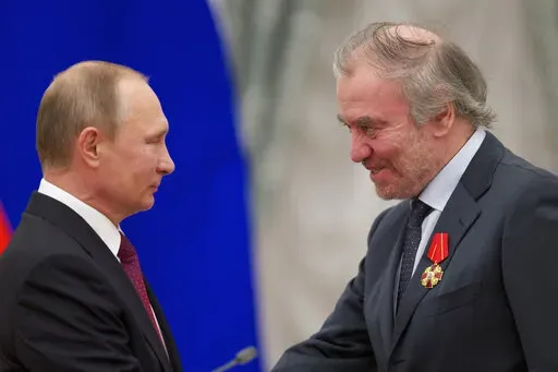 Russian President Vladimir Putin, left, presents a medal to then Mariinsky Theatre's Artistic Director Valery Gergiev, during an awarding ceremony in Moscow's Kremlin, Russia, Thursday, Sept. 22, 2016. Munich's mayor says Valery Gergiev has been fired as chief conductor of the Munich Philharmonic because of his support for Russian President Vladimir Putin and for not rejecting the invasion of Ukraine. (AP Photo/Ivan Sekretarev, pool,file)