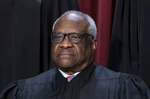 Associate Justice Clarence Thomas joins other members of the Supreme Court as they pose for a new group portrait, at the Supreme Court building in Washington, Oct. 7, 2022. The Supreme Court won’t have far to look for a personal take on the “crushing weight” of student debt that underlies the Biden administration’s college loan forgiveness plan. A legal challenge has reached the court and arguments are set for Tuesday. Thomas was in his mid-40s and in his third year on the nation's highe