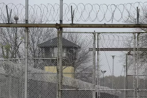 Security fences surround the Illinois Department of Corrections' Logan Correctional Center, Nov. 18, 2016, in Lincoln, Ill. Illinois Gov. J.B. Pritzker's administration has retained a contentious choice for providing medical care to prison inmates, awarding Wexford Health Sources a 10-year, $4.16 billion contract despite high vacancy rates, complaints of substandard care and lawmakers' agitation to find a replacement. (AP Photo/Seth Perlman, File)