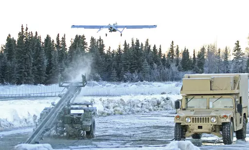 In this Jan. 30, 2014 photo, an RQ7 Shadow unmanned aircraft flies from its pneumatic catapult launcher at Joint Base Elmendorf-Richardson in Anchorage, Alaska. U.S. military bases in the Arctic and sub-Arctic are failing to harden their installations against long-term climate change as required, even though soaring temperatures and melting ice already are cracking base runways and roads and worsening flood risks up north, the Pentagon's watchdog office said April 14, 2022. (AP Photo/Dan Joling,