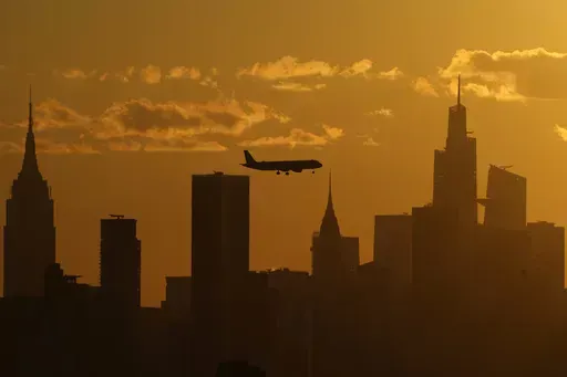 A plane flies with the New York City skyline, Thursday, Sept. 8, 2022, in New York. The ground rumbled Friday, April 5, 2024, beneath New York City, home to famous skyscrapers like the Empire State Building and One World Trade Center. Though buildings that can reach above 100 stories might seem especially vulnerable to earthquakes, engineering experts say they're built with enough flexibility to withstand them. (AP Photo/Julia Nikhinson, File)
