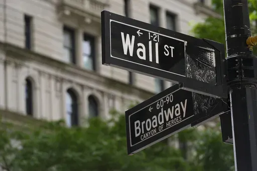 Signs at the intersection of Wall Street and Broadway streets in New York, June 12, 2024. (AP Photo/Pamela Smith, File)