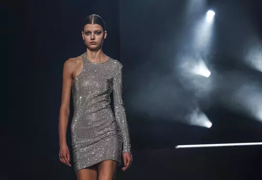 Fashion from Michael Kors' fall/winter 2022 collection is modeled during Fashion Week, Tuesday, Feb. 15, 2022, in New York. (AP Photo/Bebeto Matthews)