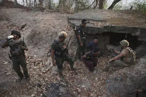 Members of the Karen National Liberation Army and People’s Defense Force examine two arrested soldiers after they captured an army outpost, in the southern part of Myawaddy township in Kayin state, Myanmar, March 11, 2024. (AP Photo/METRO)