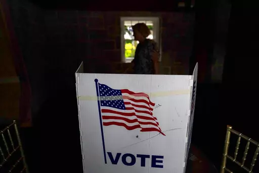 A person waits in line to vote in the Georgia's primary election on May 24, 2022, in Atlanta. A new poll shows 71% of voters think the future of the country is at stake when they vote in November's midterm elections. That's according to a new poll from The Associated Press-NORC Center for Public Affairs Research. (AP Photo/Brynn Anderson, File)