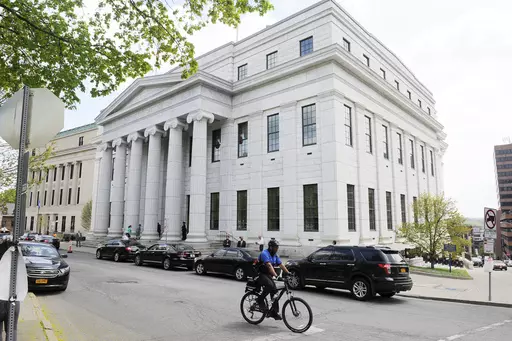 A cyclist rides past the New York Court of Appeals, May 5, 2015, in Albany, N.Y. New York’s highest court on Tuesday, Dec. 12, 2023, ordered the state to draw new congressional districts ahead of the 2024 elections, giving Democrats a potential advantage in what is expected to be a battleground for control of the U.S. House. (AP Photo/Hans Pennink, File)