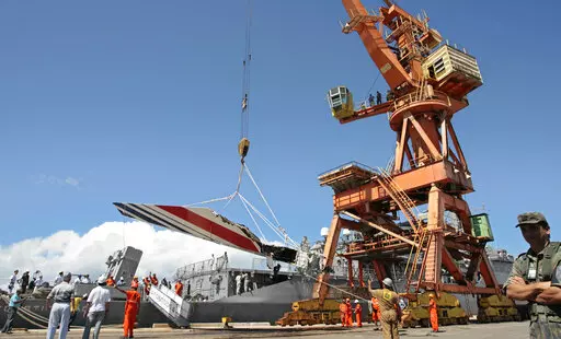 Workers unload debris, belonging to the crashed Air France flight AF447, from the Brazilian Navy's Constitution Frigate in the port of Recife, northeast of Brazil, June 14, 2009. It was the worst plane crash in Air France history, killing people of 33 nationalities and having lasting impact. It led to changes in air safety regulations, how pilots are trained and the use of airspeed sensors. (AP Photo/Eraldo Peres, File)