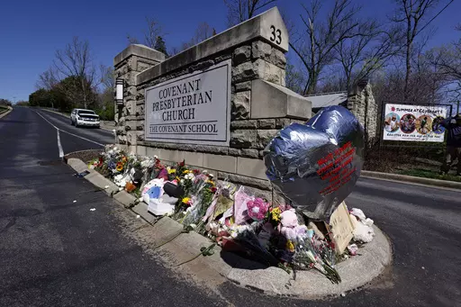 A balloon with names of the victims is seen at a memorial at the entrance to The Covenant School on Wednesday, March 29, 2023, in Nashville, Tenn. Bipartisan gun legislation signed by President Biden in 2022 has already prevented some potentially dangerous people from owning guns. But Democrats are calling for more action after mass shootings in Nashville and elsewhere, and Congress is at a familiar impasse. (AP Photo/Wade Payne, File)