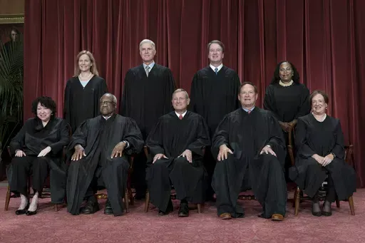 Members of the Supreme Court sit for a new group portrait following the addition of Associate Justice Ketanji Brown Jackson, at the Supreme Court building in Washington, on Oct. 7, 2022. Bottom row, from left, Associate Justice Sonia Sotomayor, Associate Justice Clarence Thomas, Chief Justice of the United States John Roberts, Associate Justice Samuel Alito, and Associate Justice Elena Kagan. Top row, from left, Associate Justice Amy Coney Barrett, Associate Justice Neil Gorsuch, Associate Justi