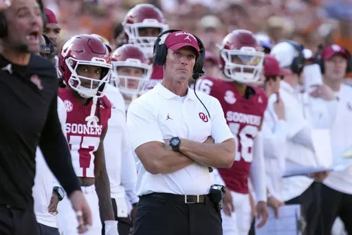 Oklahoma head football coach Brent Venables, center, watches play against Texas late in the second half of an NCAA college football game in Dallas, Saturday, Oct. 12, 2024. (AP Photo/Jeffrey McWhorter)