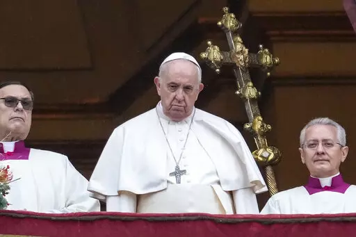 Pope Francis looks at the crowd after delivering the Urbi et Orbi (Latin for 'to the city and to the world' ) Christmas' day blessing from the main balcony of St. Peter's Basilica at the Vatican, Saturday, Dec. 25, 2021. (AP Photo/Gregorio Borgia)