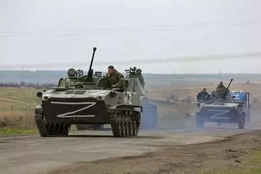Russian military vehicles move on a highway in an area controlled by Russian-backed separatist forces near Mariupol, Ukraine, April 18, 2022. (AP Photo/Alexei Alexandrov, File)
