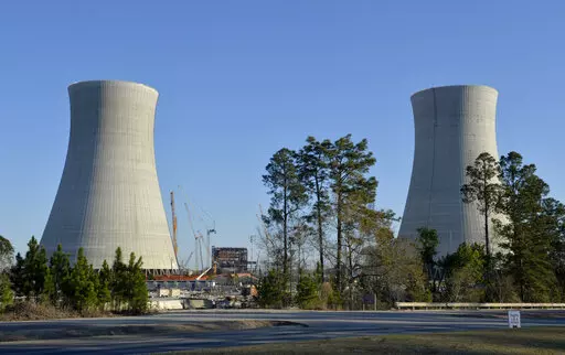 The cooling towers of the still under construction Plant Vogtle nuclear energy facility in Waynesboro, Ga., Friday, March 22, 2019.   One of the owners of the plant announced Saturday, June 18, 2022, that it was freezing its costs and forcing Georgia Power Co. to assume all future overruns, giving up a share of its ownership to Georgia Power.  (Michael Holahan/The Augusta Chronicle via AP)