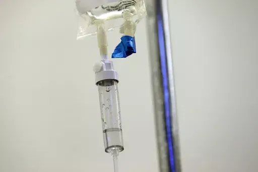 In this May 25, 2017 file photo, chemotherapy drugs are administered to a patient at a hospital in Chapel Hill, N.C. Scaling back treatment in some cancers — ovarian, esophageal and Hodgkin lymphoma — can make life easier for patients without compromising outcomes, doctors reported at the American Society of Clinical Oncology annual meeting in early June 2024. (AP Photo/Gerry Broome, File)
