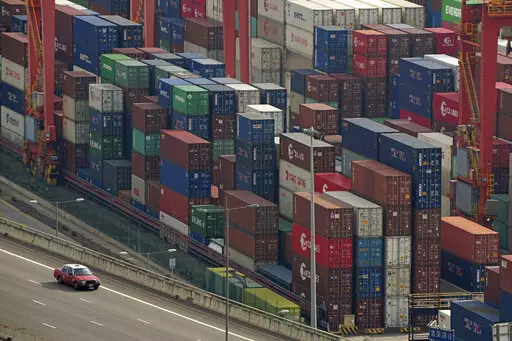 Shipping containers are seen at a port of Kwai Tsing Container Terminals in Hong Kong, Friday, Nov. 5, 2021. The United States has accused China in a report Wednesday, Feb. 16, 2022, of failing to meet its commitments to the World Trade Organization. (AP Photo/Kin Cheung, File)