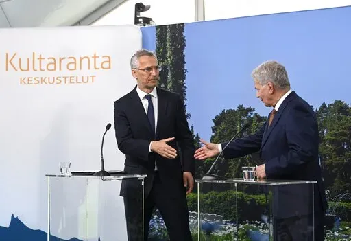 Finland's President Sauli Niinisto meets with NATO Secretary General Jens Stoltenberg, left, shake hands at a press conference during Kultaranta Talks, at the presidential summer residence Kultaranta in Naantali, Finland, Sunday June 12, 2022. (Markku Ulander/Lehtikuva via AP)