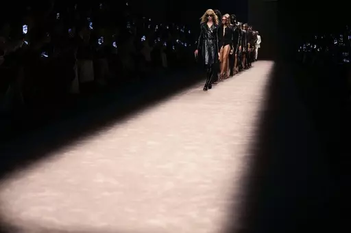 Models wear creations as part of the Tom Ford women's Spring Summer 2024 collection presented in Milan, Italy, Thursday, Sept. 21, 2023. (AP Photo/Antonio Calanni)