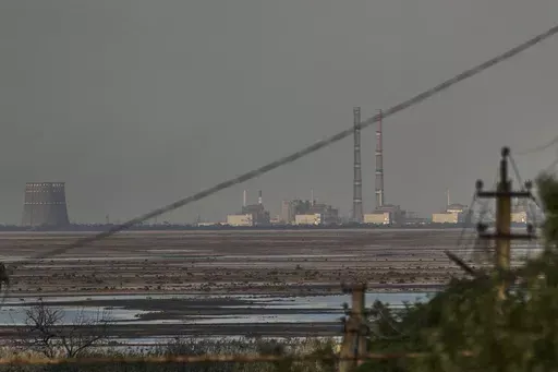 The Zaporizhzhia nuclear power plant, Europe's largest, is seen in the background of the shallow Kakhovka Reservoir after the dam collapse, in Energodar, Russian-occupied Ukraine, Tuesday, June 27, 2023. Officials at the Russian-controlled Zaporizhzhia Nuclear Power Plant said that the site was attacked Sunday April 7, 2024, by Ukrainian military drones, including a strike on the dome of the plant’s sixth power unit. (AP Photo/Libkos, File)