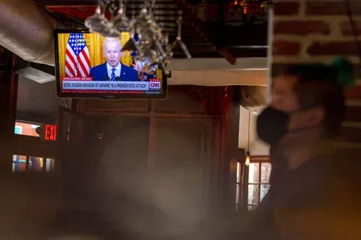 President Joe Biden speaks about Russia's invasion of Ukraine on a television at Shaws Tavern in Washington, Feb. 24, 2022. Biden will deliver his State of the Union address to a joint session of Congress on Tuesday, March 1. (AP Photo/Andrew Harnik, File)
