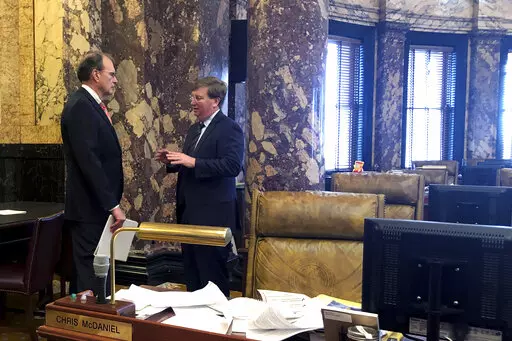 Lt. Gov. Delbert Hosemann, left, and Gov. Tate Reeves confer in an empty Senate chamber at the Mississippi State Capitol in Jackson, Miss., Tuesday, Feb. 1, 2022. (AP Photo/Emily Wagster Pettus)