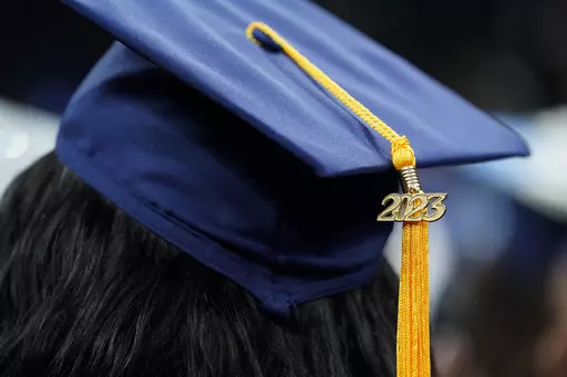 A tassel with 2023 on it rests on a graduation cap as students walk in a procession for Howard University's commencement in Washington, Saturday, May 13, 2023. The Supreme Court is getting ready to decide some of its biggest cases of the term, including the fate of President Joe Biden’s plan to wipe away or reduce student loans held by millions of Americans. (AP Photo/Alex Brandon, File)