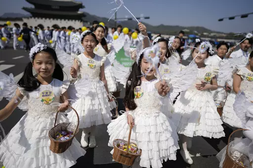 Children dressed as angels march during an Easter parade in Seoul, South Korea, on April 9, 2023. A new law that went into effect Wednesday, June 28, formalizes the international age-counting method as standard in administrative and civil laws and encourages people to tally their own ages accordingly. The country's previous age-counting method made people a year or two older than they really are. (AP Photo/Lee Jin-man, File)