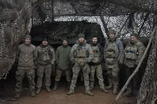 Soldiers of 12th Special Forces Brigade Azov of the National Guard pose for a photo at the 155mm self-propelled gun M109 Paladin at the front line, near Kreminna, Luhansk region, Ukraine, Sunday, Jan. 28, 2024. The U.S. has removed restrictions on the transfer of American weapons and training to a high-profile Ukrainian military unit with a checkered past, the State Department said on Tuesday, June 11, 2024. (AP Photo/Efrem Lukatsky, File)