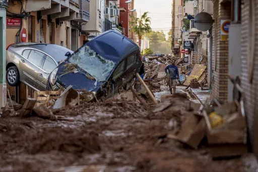 A man walks through a street affected by floods in Valencia, Spain, Nov. 2, 2024. (AP Photo/Manu Fernandez, File)
