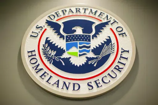 The Homeland Security logo is seen during a joint news conference in Washington, Feb. 25, 2015. The Homeland Security Department said Friday that Cameroonians would be temporarily shielded from deportation, saying extreme violence between government forces and armed separatists in the African nation made conditions unsafe for people to return. (AP Photo/Pablo Martinez Monsivais, File)