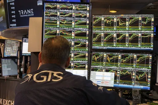 A specialist studies monitors on the New York Stock Exchange trading floor in New York on November 21, 2024. (AP Photo/Ted Shaffrey, File)