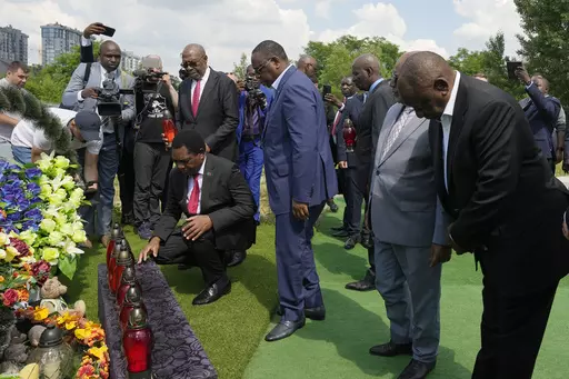 From right, South African President Cyril Ramaphosa, President of the Union of Comoros Azali Assoumani, Senegal's President Macky Sall, and Zambia's President Hakainde Hichilema, bottom, attend a commemoration ceremony at a site of a mass grave in Bucha, on the outskirts of Kyiv, Ukraine, Friday, June 16, 2023. South African President Cyril Ramaphosa arrived in Ukraine on Friday as part of a delegation of African leaders and senior officials seeking ways to end Kyiv's 15-month war with Russia. (