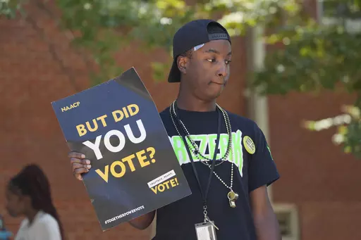 A Jackson State University student holds a sign stressing the importance of voting during a JSU Votes Civic Engagement Initiative on National Voter Registration Day, Sept. 19, 2023, on the Jackson, Miss., campus. According to information from the Mississippi Secretary of State's Office, the number of registered voters in the state has remained steady during the months leading to the Nov. 7 election for governor and other offices. (AP Photo/Rogelio V. Solis, File)