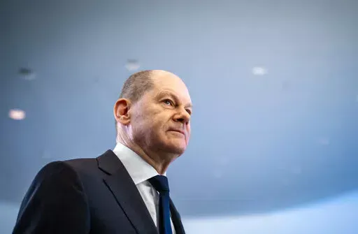German Chancellor Olaf Scholz leaves after a news conference, ahead of a one-day closed meeting of the German Cabinet at the Chancellery in Berlin, Germany, Friday, Jan. 21, 2022.  Scholz is flying to Washington this week to reassure Americans that his country stands alongside the United States and other NATO partners in opposing any Russian aggression against Ukraine. Scholz has publicly said that Moscow would pay a “high price” in the event of an attack. But his government’s refusal to s