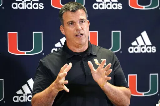 Miami head coach Mario Cristobal talks with the media at the team's NCAA college football media day, Tuesday, Aug. 2, 2022, in Coral Gables, Fla. Cristobal isn't the only coach who came home to Miami. The Hurricanes have no shortage of assistants and analysts with deep Miami ties who signed on to join Cristobal's first staff at his alma mater. (AP Photo/Lynne Sladky, File)